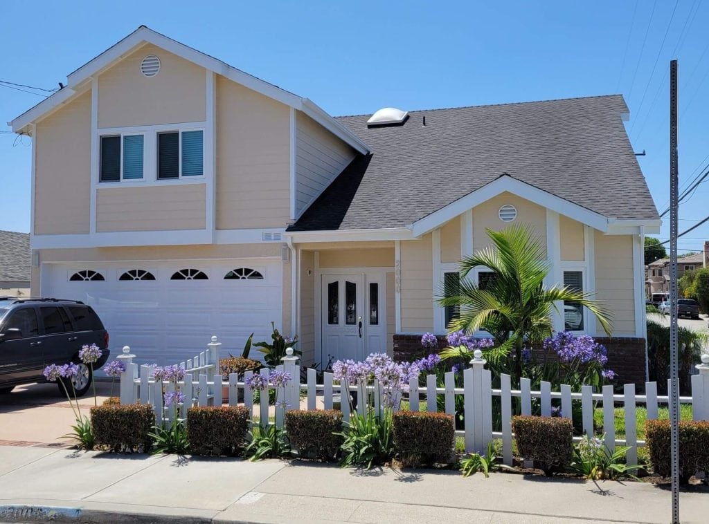 Two-story home in Palos Verdes Estates with fresh yellow siding and white trim
